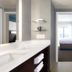 Residence Inn by Marriott Myrtle Beach Oceanfront bathroom with vanity, walk-in shower and bedroom view