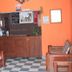 Acuarela Huasteca in Ciudad Valles lobby with wooden front desk, orange walls and checkered tile floor