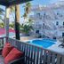 La Isla Resort, Caye Caulker: pool courtyard with palm trees, balconies, and spiral staircases