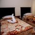 Sedrah Hotel in Irbid: twin beds with swan towel art and patterned bedspreads beside a sunlit window