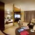 Shuguang Liting Hotel Ningbo suite with seating area, TV desk, and bedroom in Ningbo