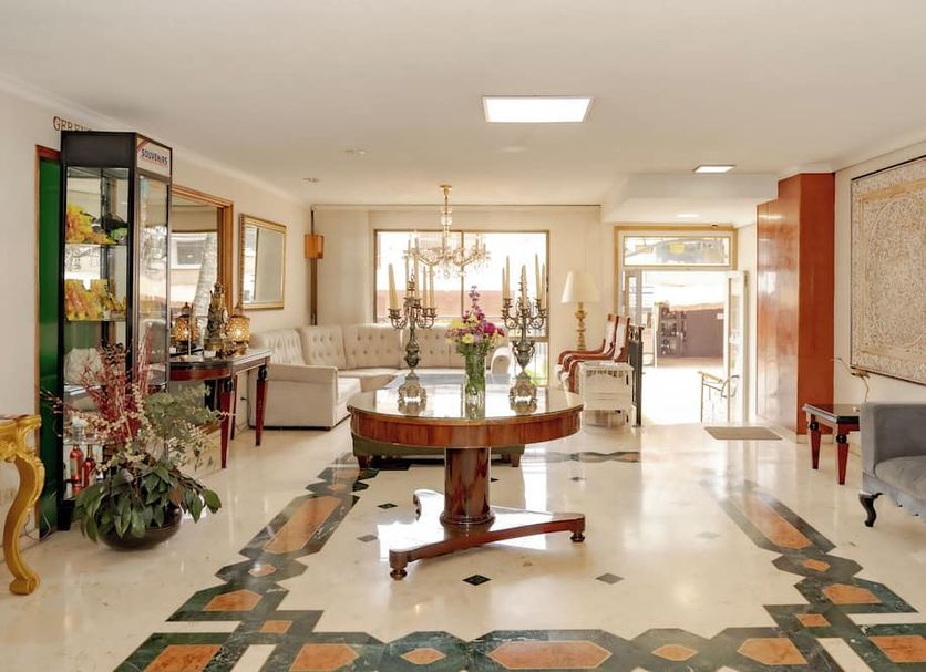 Hotel San Pedro del Fuerte in Medellín lobby with chandelier, glass table, and seating area