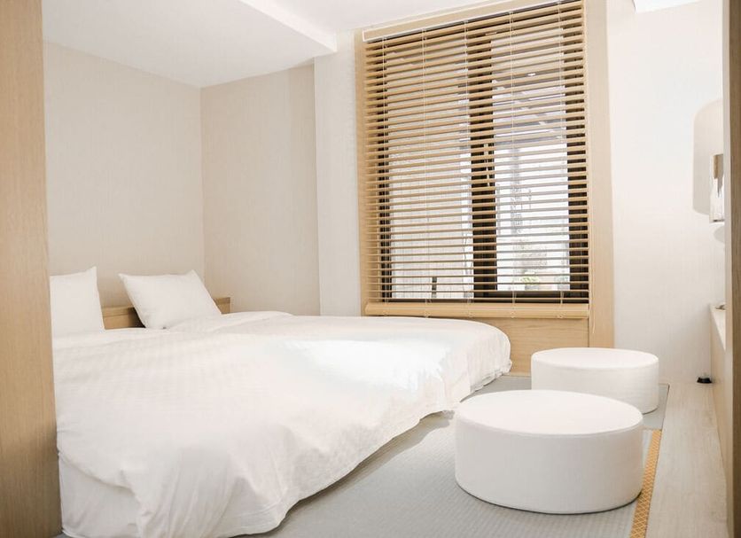 Check Inn Express Taipei Station room with twin beds and round ottomans, Taipei City
