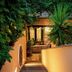 Marulivo Hotel in Pisciotta: lush plant-lined stairway leading to a warmly lit courtyard