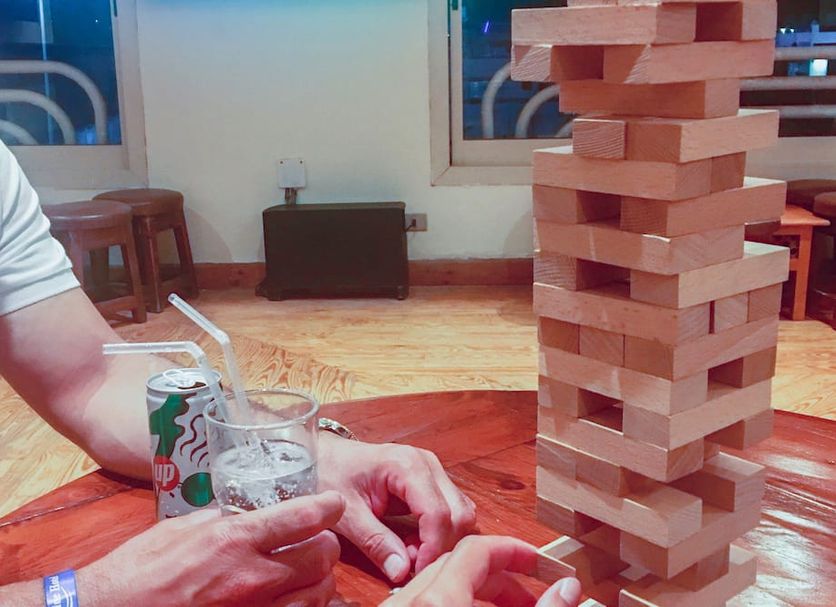 Naama Blue Hotel in Sharm el-Sheikh with guests playing giant Jenga at a wooden table