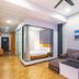 Nova Highlands Hotel Brinchang suite with glass-walled bedroom, sofa, coffee table and wood flooring