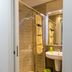 Domatia Barletta bathroom with glass shower, sink and towel rack