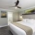 Westgate Branson Lakes Resort guest room in Hollister with king bed, ceiling fan, and lakeside wall art