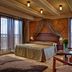 Majestic Plaza Hotel Prague room with king bed, large windows, city views and seating area in Prague