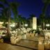 Bahia Principe Grand Coba in Akumal: palm-lined evening lounge with white seating and lit stone pathway