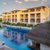 Paradisus La Perla – Adults Only in Playa del Carmen with pool, umbrellas and resort balconies at sunset