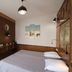 Hotel Rachel room in Le Pré-Saint-Gervais with double bed, wood-paneled walls and en suite bathroom