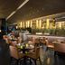 Hilton Qingdao Golden Beach restaurant with warm lighting, tables, and chairs in Qingdao