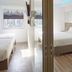 Easy Planet Bangkok Surawong guest room with twin beds, desk, and city-view windows in Bangkok