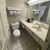 Baymont by Wyndham Casper East bathroom in Evansville with sink, toilet, mirror and shower curtain