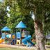 Blue Lake Holiday Park in Mount Gambier: colorful children's playground among leafy trees