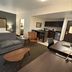 Best Western Plus Chihuahua Juventud suite with bed, sofa, desk and kitchenette in Chihuahua