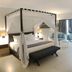 Sand & Sandals Desaru Beach Resort & Spa room with four-poster bed, balcony doors and ocean view in Bandar Penawar