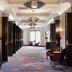Sheraton Nashville Brentwood hallway with patterned carpet, lounge chairs, and bright windows in Brentwood