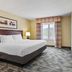 Country Inn & Suites by Radisson Princeton, WV guest room with king bed, TV, and window view