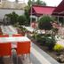 Hotel Baykal in Bogazkale outdoor garden patio with tables, orange chairs, and red awnings