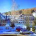 Casa Octavian in Suceviţa with snowy courtyard, parked cars, and mountain backdrop