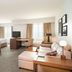 Residence Inn by Marriott New Bedford Dartmouth suite with sofa, desk, dining table and TV