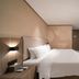 Hanting Hotel Dongguan Changan Wanda room with queen bed, wall-mounted TV, and desk in Dongguan