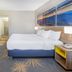 Days Inn Roanoke Near I-81 room with king bed, desk, TV and mountain artwork in Roanoke