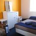 Abel's Central Backpackers in Nelson room with double bed, dresser and window