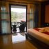 Phu Chom Mork Resort room with king bed and balcony view of mountains in Sangkhla Buri