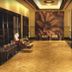 The Retreat Hotel & Convention Centre Mumbai lobby with polished wood floor and floral wall mural