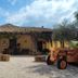 Agriturismo Baglio Vecchio in Castelvetrano with rustic courtyard, tiled roof, and vintage tractor
