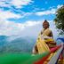 Stupa Resort in Nagarkot with a Buddha statue overlooking misty green mountains and blue sky