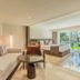 Grand Palladium Bavaro Suites Resort & Spa Punta Cana suite with sofa, bed, patio view and desk