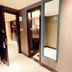 Ramada Plaza by Wyndham Tian Lu Hotel Wuhan hallway with open room doors and a wall mirror