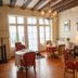 La Demeure Saint-Ours in Loches: elegant breakfast room with chandeliers, wooden beams and set dining tables