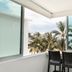 Hotel Villa Varadero in Nuevo Vallarta balcony with chairs and tropical palm tree ocean view