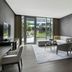 Four Seasons Hotel Bengaluru at Embassy One suite with living area, balcony doors, and garden view in Bengaluru