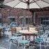 Dog and Partridge by Greene King Inns courtyard patio in Bury St. Edmunds with tables, chairs and umbrellas