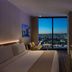 AC Hotels by Marriott Los Downtown Los Angeles room with city skyline view at dusk