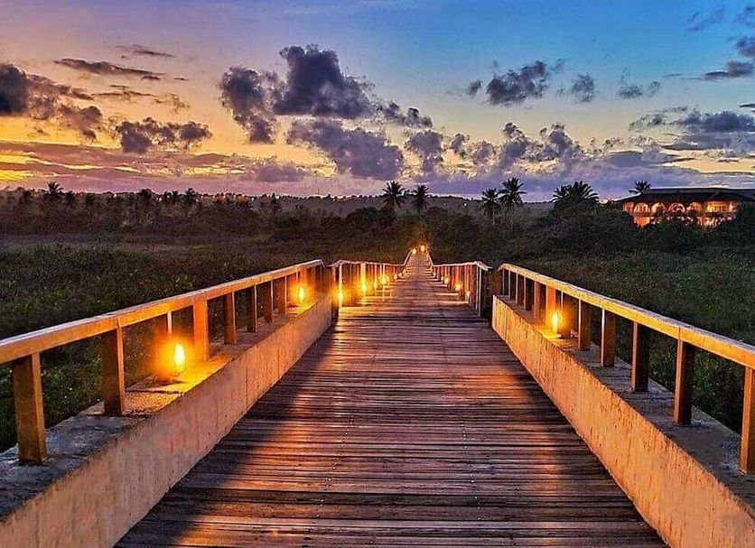Grand Palladium Imbassai Resort And Spa boardwalk at sunset in Mata de São João with glowing path lights