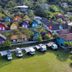Hotel Vale Verde Penedo in Penedo with colorful cottages, green lawn, and hillside views