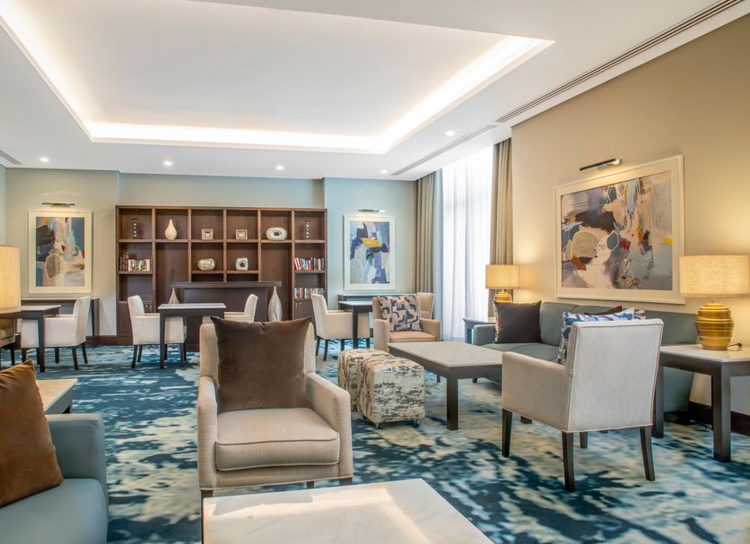 Staybridge Suites Cairo - Citystars lounge with seating area, blue patterned carpet, and wall art in Cairo