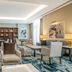 Staybridge Suites Cairo - Citystars lounge with seating area, blue patterned carpet, and wall art in Cairo