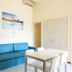 Del Garda Village and Camping in Peschiera del Garda room with blue sofa, table and bed