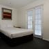 The Waterloo Bay Hotel in Brisbane room with two twin beds and French doors to a balcony