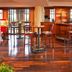 Sheraton Atlanta Airport Hotel bar with high-top stools and polished wood flooring in Atlanta