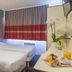 Appart'City La Rochelle twin room with two beds, desk, and window with curtains
