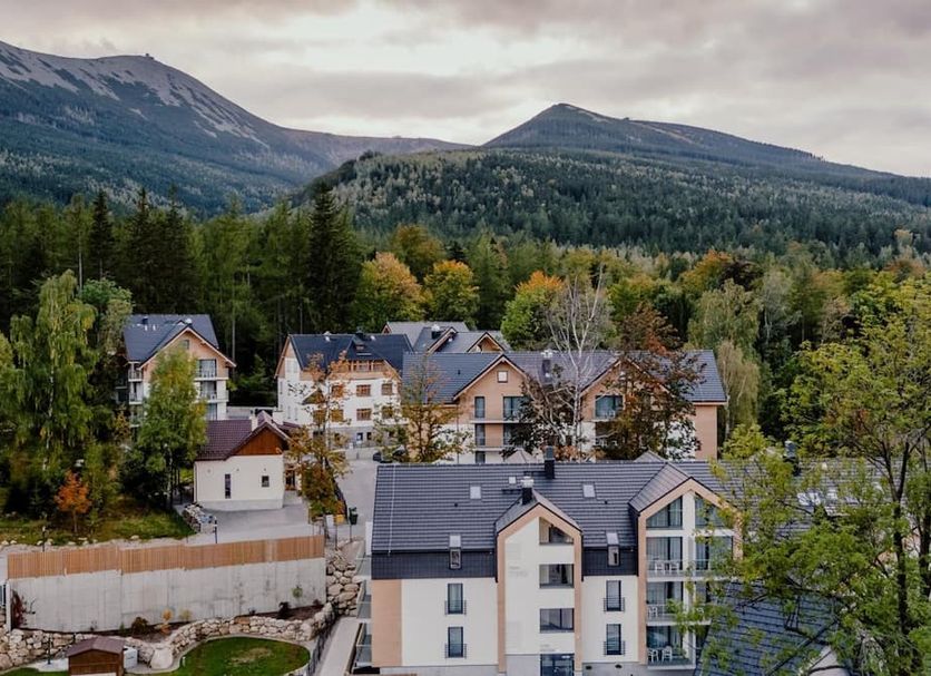 Green Apartments in Karpacz with mountain backdrop and forested surroundings